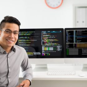 Portrait of smiling young Vietnamese software engineer